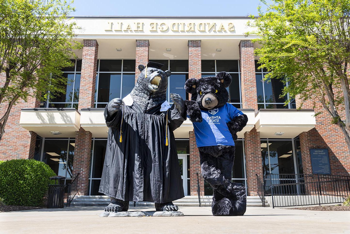 Hebrew the Bear posing with his statue